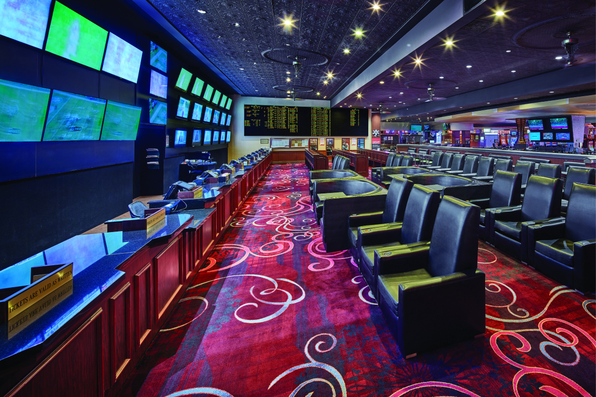 William Hill Sportsbook at Rio Hotel & Casino with numerous TV screens and leather chairs