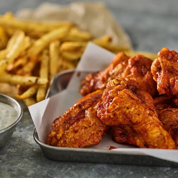 Spicy chicken wings with fries and dip