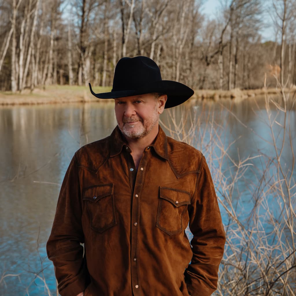 Tracy Lawrence standing next to a lake